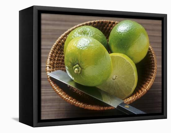 Limes, Two Whole and One Halved in a Small Basket-Eising Studio - Food Photo and Video-Framed Stretched Canvas