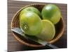 Limes, Two Whole and One Halved in a Small Basket-Eising Studio - Food Photo and Video-Mounted Photographic Print