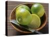 Limes, Two Whole and One Halved in a Small Basket-Eising Studio - Food Photo and Video-Stretched Canvas