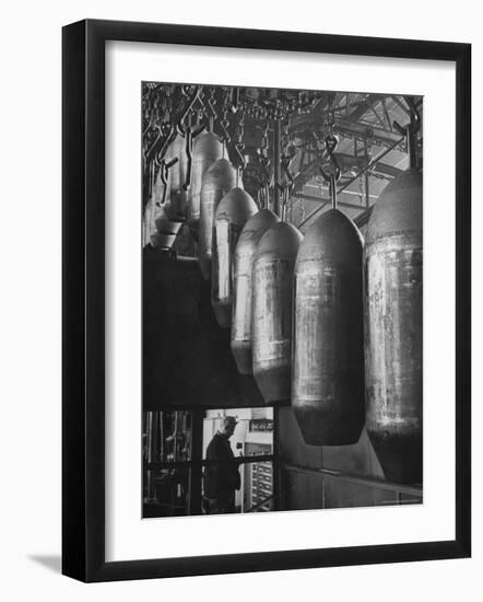 Line of 500 lbs Bombs Jiggling Along on Overhead Conveyor Hooks Abover Worker-Andreas Feininger-Framed Photographic Print