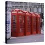 Line of Four Red Telephone Boxes at Charing Cross, London, England, United Kingdom, Europe-Roy Rainford-Stretched Canvas