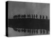 Line of Soldiers on Ridge Silhouetted Against Sky Reflected from River Beside Them-null-Stretched Canvas