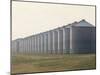 Line of Storage Bins for Corn, Unidentified Section of the Mid-West-John Zimmerman-Mounted Photographic Print