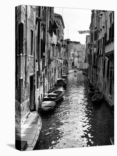 Lines of Laundry Hang Between Residential Buildings-null-Stretched Canvas