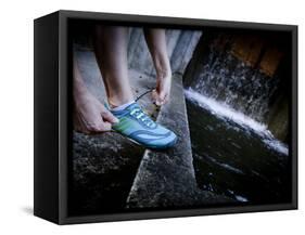 Lisa Eaton Laces Up Her Running Shoe Near a Water Feature at Freeway Park - Seattle, Washington-Dan Holz-Framed Stretched Canvas
