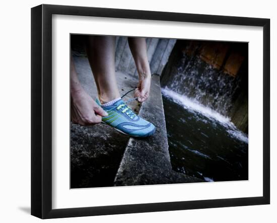 Lisa Eaton Laces Up Her Running Shoe Near a Water Feature at Freeway Park - Seattle, Washington-Dan Holz-Framed Photographic Print