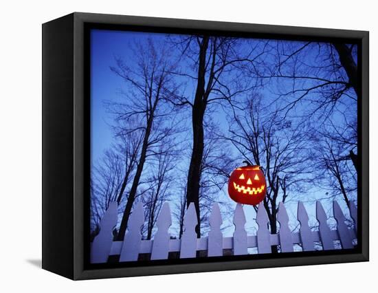 Lit Jack o'-Lantern Perched on Picket Fence-Ralph Morsch-Framed Stretched Canvas