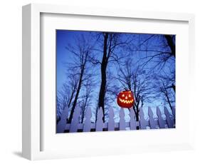 Lit Jack o'-Lantern Perched on Picket Fence-Ralph Morsch-Framed Photographic Print