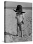 Little Boy at the Beach Wearing a Oversized Cowboy Hat Playing with a Toy Pistol-Ralph Crane-Stretched Canvas