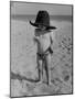 Little Boy at the Beach Wearing a Oversized Cowboy Hat Playing with a Toy Pistol-Ralph Crane-Mounted Photographic Print