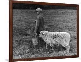 Little Boy Carring a Metal Pail of Feed is Followed by a Hungry Sheep!-null-Framed Photographic Print