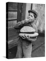 Little Boy Holding Loaves of Bread-Walter Sanders-Stretched Canvas