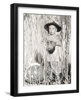 Little Boy in Halloween Costume Holding Mask Standing by Streamers-null-Framed Photo