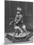 Little Boy on a Very Small Rocking Horse with a Whip in His Hand-null-Mounted Photographic Print