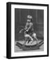 Little Boy on a Very Small Rocking Horse with a Whip in His Hand-null-Framed Photographic Print