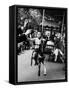 Little Boy on Merry Go Round at the Tuileries Gardens, Sticking Out His Tongue-Alfred Eisenstaedt-Framed Stretched Canvas