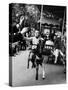 Little Boy on Merry Go Round at the Tuileries Gardens, Sticking Out His Tongue-Alfred Eisenstaedt-Stretched Canvas