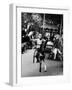 Little Boy on Merry Go Round at the Tuileries Gardens, Sticking Out His Tongue-Alfred Eisenstaedt-Framed Photographic Print