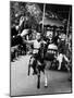 Little Boy on Merry Go Round at the Tuileries Gardens, Sticking Out His Tongue-Alfred Eisenstaedt-Mounted Photographic Print