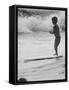 Little Boy Standing on a Surf Board Staring at the Water-Allan Grant-Framed Stretched Canvas