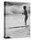 Little Boy Standing on a Surf Board Staring at the Water-Allan Grant-Stretched Canvas