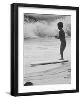 Little Boy Standing on a Surf Board Staring at the Water-Allan Grant-Framed Photographic Print