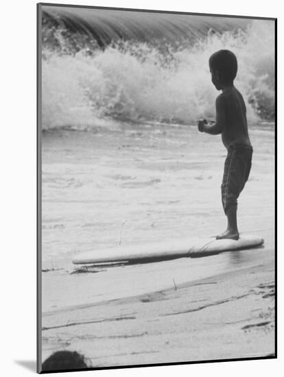 Little Boy Standing on a Surf Board Staring at the Water-Allan Grant-Mounted Photographic Print