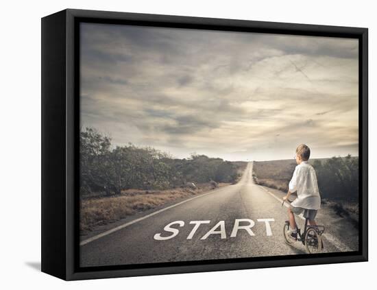 Little Child Pedaling a Bicycle on a Deserted Road-olly2-Framed Stretched Canvas