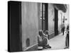 Little Girl Cleaning Face of a Street Beggar-null-Stretched Canvas