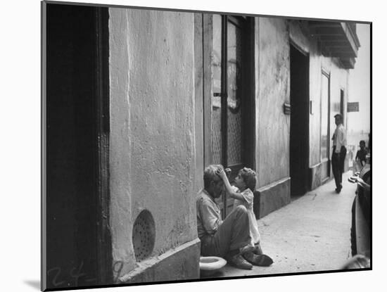 Little Girl Cleaning Face of a Street Beggar-null-Mounted Photographic Print