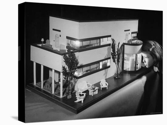 Little Girl Looking Into a Modern Doll House Being Sold at F.A.O. Schwarz-Herbert Gehr-Stretched Canvas