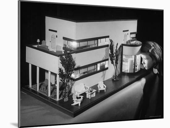 Little Girl Looking Into a Modern Doll House Being Sold at F.A.O. Schwarz-Herbert Gehr-Mounted Photographic Print