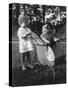 Little Girl Pushes Her Teddy Bear Around in a Pram-null-Stretched Canvas