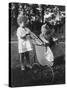 Little Girl Pushes Her Teddy Bear Around in a Pram-null-Stretched Canvas