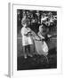 Little Girl Pushes Her Teddy Bear Around in a Pram-null-Framed Photographic Print