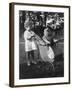 Little Girl Pushes Her Teddy Bear Around in a Pram-null-Framed Photographic Print