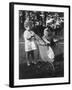 Little Girl Pushes Her Teddy Bear Around in a Pram-null-Framed Photographic Print