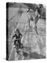 Little Girl Riding Her Tricycle, Leading Francis the Mule-Allan Grant-Stretched Canvas