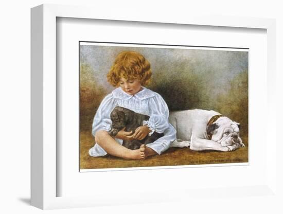 Little Girl Sits with a White Bulldog and Cuddles a Puppy-null-Framed Photographic Print