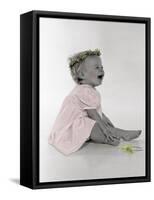 Little Girl Sitting and Laughing with a Floral Ring on Head and Two Flowers in Front of Her-Nora Hernandez-Framed Stretched Canvas