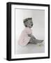 Little Girl Sitting and Laughing with a Floral Ring on Head and Two Flowers in Front of Her-Nora Hernandez-Framed Giclee Print