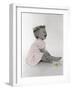 Little Girl Sitting and Laughing with a Floral Ring on Head and Two Flowers in Front of Her-Nora Hernandez-Framed Giclee Print