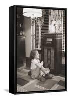 Little Girl Smiles as She Enjoys a Radio Program in the 1930s-null-Framed Stretched Canvas