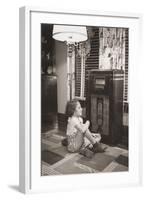 Little Girl Smiles as She Enjoys a Radio Program in the 1930s-null-Framed Photo