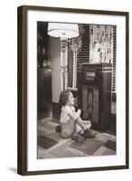 Little Girl Smiles as She Enjoys a Radio Program in the 1930s-null-Framed Photo