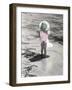 Little Girl Standing at Edge of Water with Pail over Her Head-Nora Hernandez-Framed Giclee Print