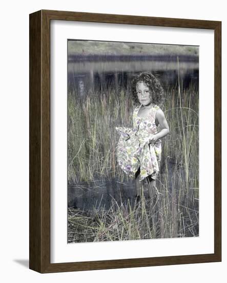 Little Girl Standing in Pond Surrounded by Tall Grass-Nora Hernandez-Framed Giclee Print