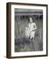 Little Girl Standing in Pond Surrounded by Tall Grass-Nora Hernandez-Framed Giclee Print