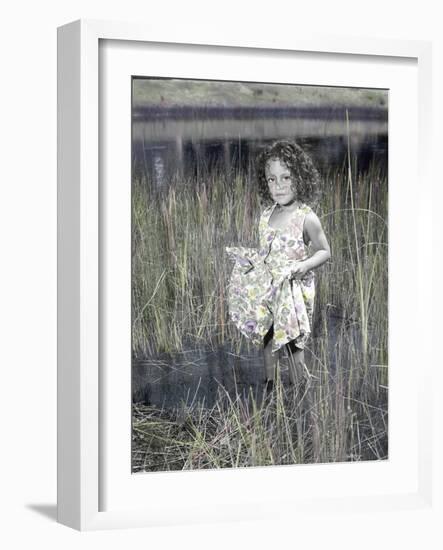 Little Girl Standing in Pond Surrounded by Tall Grass-Nora Hernandez-Framed Giclee Print