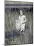 Little Girl Standing in Pond Surrounded by Tall Grass-Nora Hernandez-Mounted Giclee Print